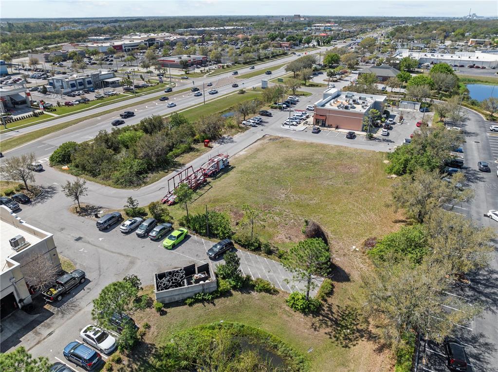 An aerial view shows a vacant lot surrounded by commercial buildings, parking lots, and roads — BIG BEND ROAD, RIVERVIEW, FL
