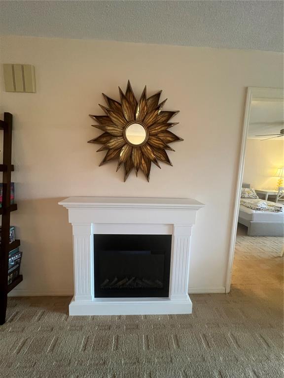 An entryway features a tiled floor, a console table, a gold-framed mirror, and louvered closet doors — 338 CERROMAR WAY N UNIT 4, VENICE, FL