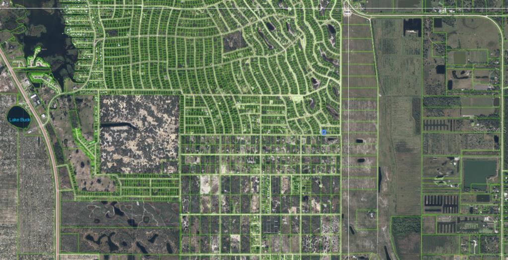 An aerial map view showing a residential neighborhood with plotted property lines and surrounding land — 210 IMPATIENS STREET, LAKE PLACID, FL