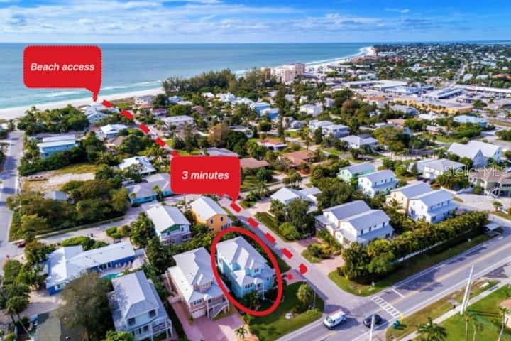 An aerial view shows a light blue house with a red circle and path to beach — 4808 GULF DRIVE UNIT B, HOLMES BEACH, FL