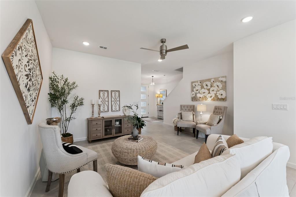 A kitchen features dark wood cabinets, granite countertops, a center island, and stainless steel appliances — 1070 SPRING PALMS LOOP, ORLANDO, FL
