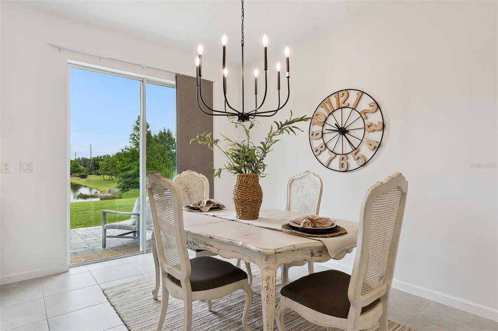 A bright living room features light tile floors, a ceiling fan, and neutral-toned furniture — 1070 SPRING PALMS LOOP, ORLANDO, FL