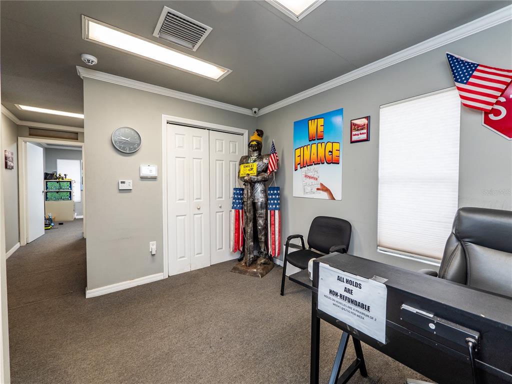 An office interior features a suit of armor, a desk, and a "We Finance" sign — 3001 S PINE AVENUE, OCALA, FL