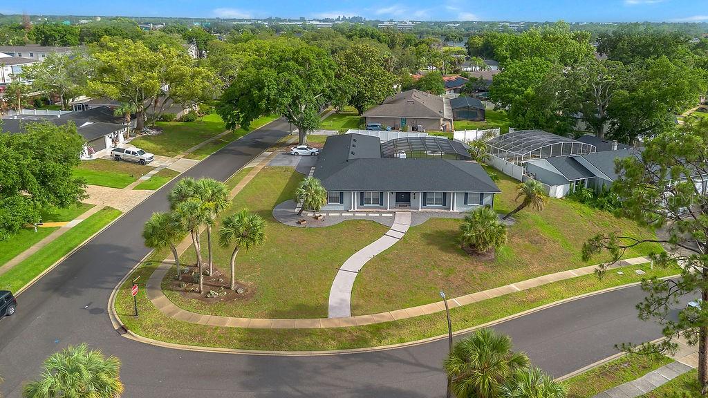 An aerial view shows a single-story house with a dark roof on a corner lot — 105 SPRING COVE TRAIL, ALTAMONTE SPRINGS, FL