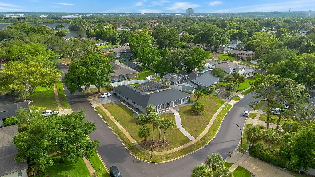 An aerial view of a suburban house with a screened-in pool and a corner lot — 105 SPRING COVE TRAIL, ALTAMONTE SPRINGS, FL