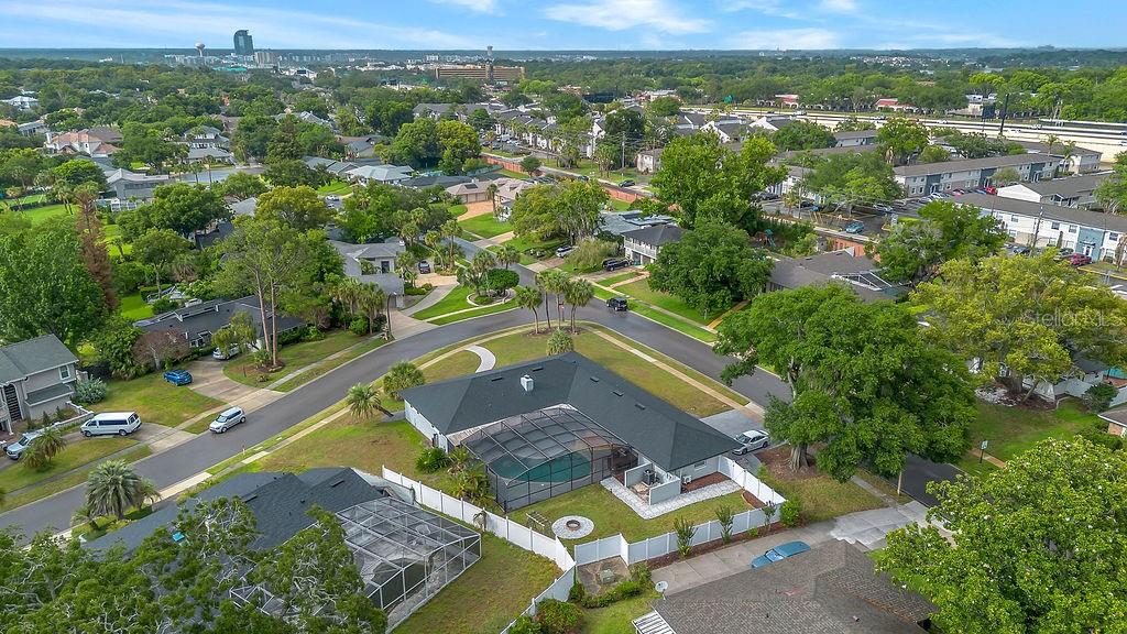 An aerial view shows a residential neighborhood with a house featuring a screened-in pool — 105 SPRING COVE TRAIL, ALTAMONTE SPRINGS, FL