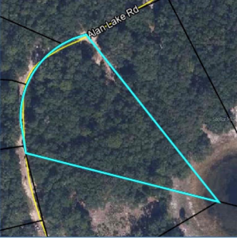 An aerial map view shows a wooded, triangular-shaped plot of land bordering a lake — 4586 ALAN LAKE ROAD, KEYSTONE HEIGHTS, FL