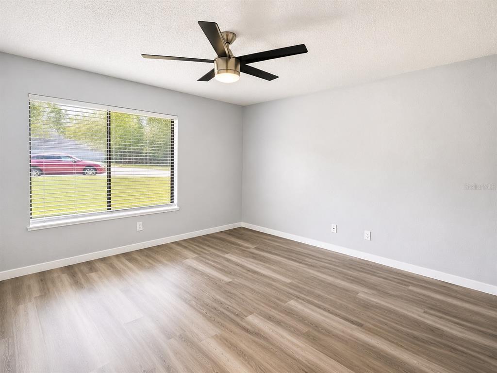 A dining room features a wooden table, six chairs, a sideboard, and sliding glass doors — 5 HICKORY TRACK RUN, OCALA, FL