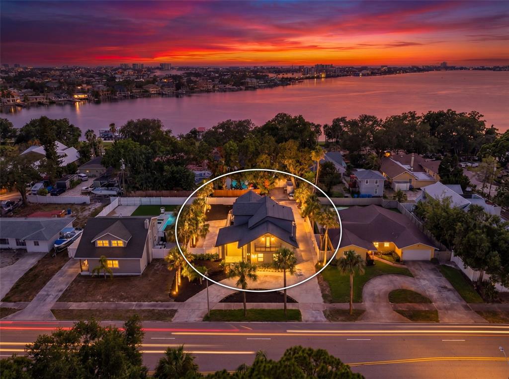 A two-story gray house with a balcony, dark trim, and a concrete driveway — 310 PARK STREET N, ST PETERSBURG, FL