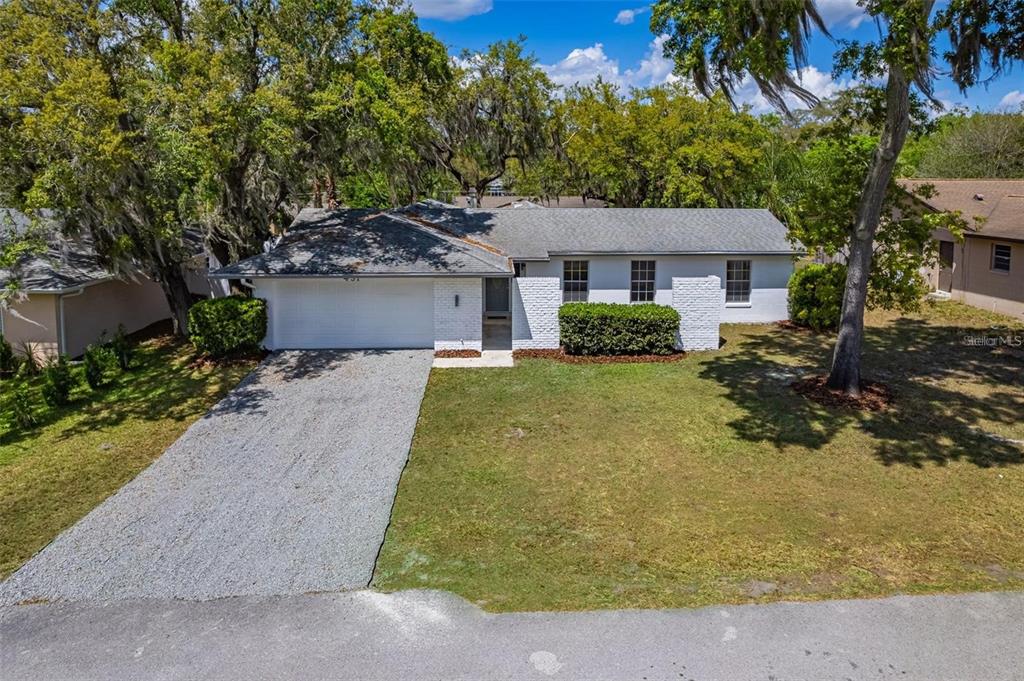A single-story white brick house with a gravel driveway and a gray shingled roof — 437 ALPINE STREET, ALTAMONTE SPRINGS, FL