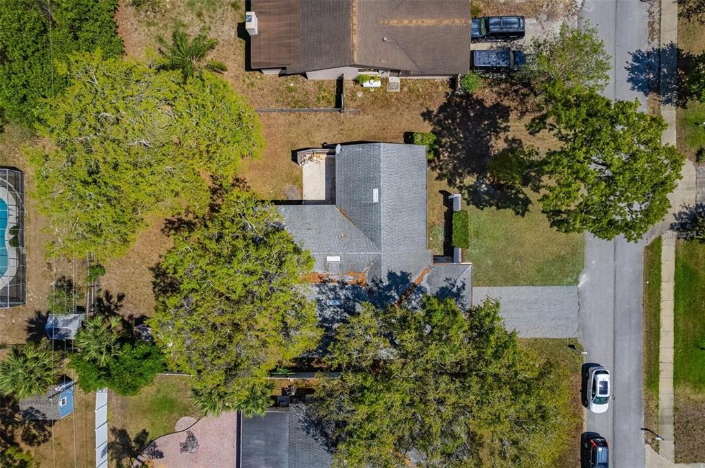 An aerial view shows a house with a gray roof surrounded by trees and grass — 437 ALPINE STREET, ALTAMONTE SPRINGS, FL