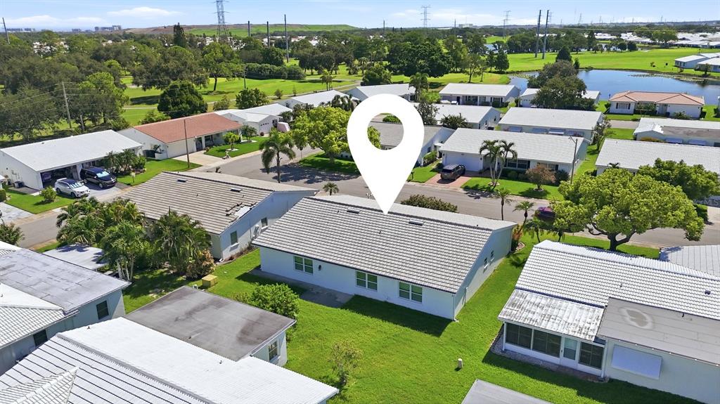 An aerial view shows a white single-story house with a tiled roof and lawn — 9304 41ST STREET N, PINELLAS PARK, FL