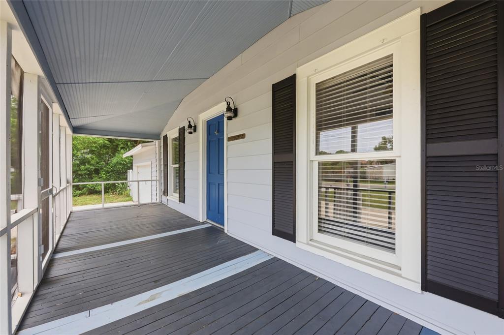 A kitchen with a central island, stainless steel appliances, and light green walls — 4114 E MICHIGAN STREET, ORLANDO, FL