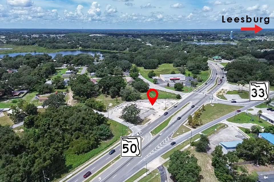 An aerial view shows a vacant lot at the intersection of State Road 50 and 33 — E MYERS BOULEVARD, MASCOTTE, FL