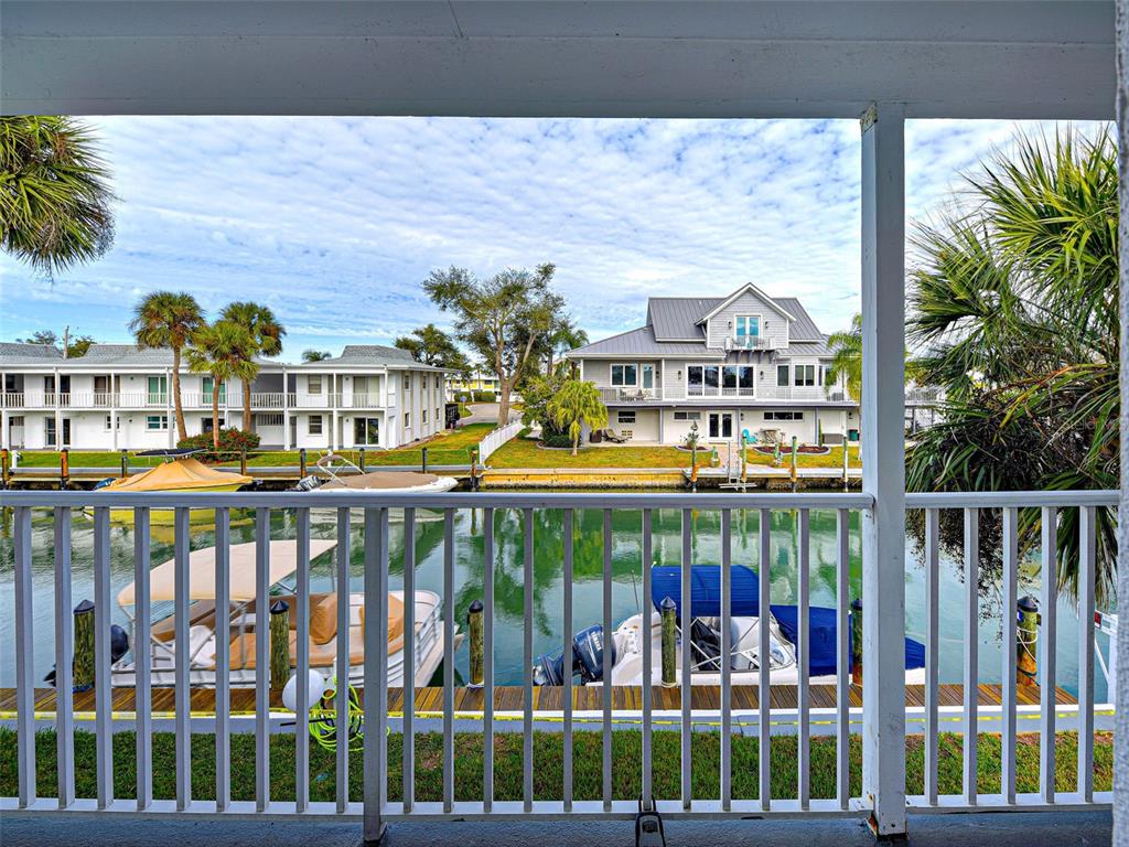 A view from a balcony overlooking a canal with boats and waterfront houses — 902 GIBBS ROAD UNIT 285, VENICE, FL