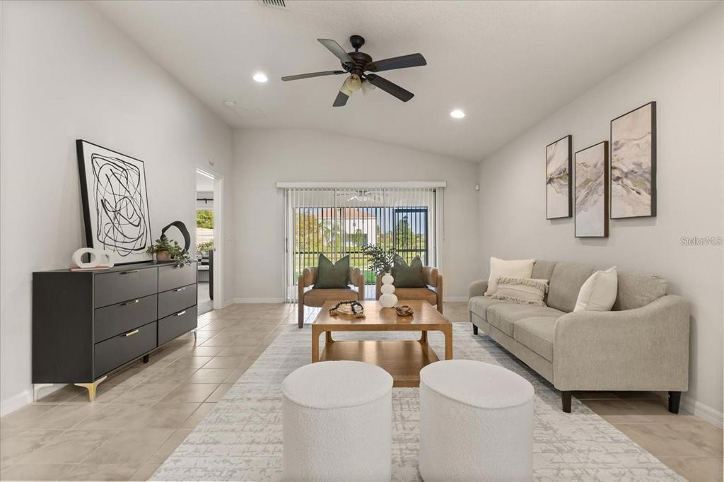 A living room features a beige sofa, two armchairs, a coffee table, and tile flooring — 12223 PESCARA LANE, ORLANDO, FL