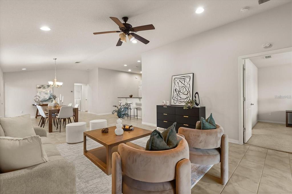 A living room with tile floors, a ceiling fan, and an open dining area — 12223 PESCARA LANE, ORLANDO, FL