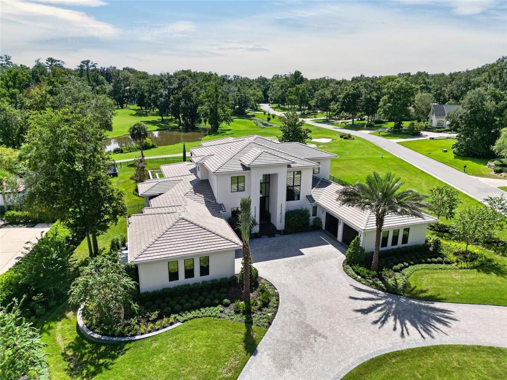 An aerial view of a modern two-story house with a tiled roof and paved driveway — TBD SE 12 CIRCLE, OCALA, FL