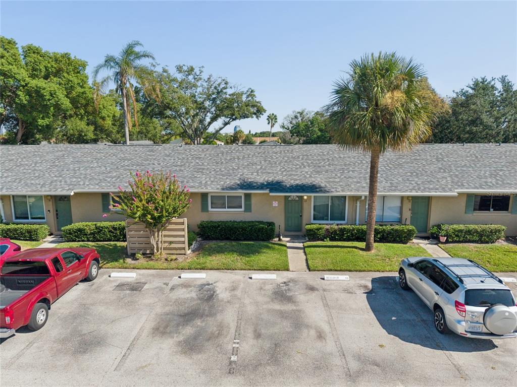 An exterior view of a single-story apartment building with a parking lot in front — 725 NORTHLAKE BOULEVARD UNIT 10, ALTAMONTE SPRINGS, FL