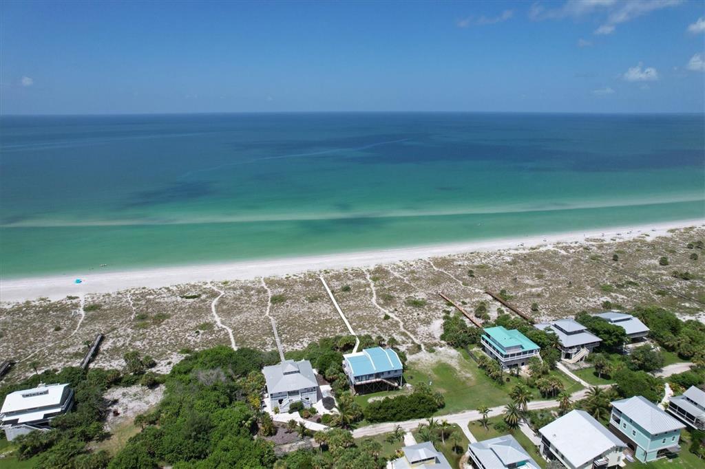 An aerial view of beachfront houses with wooden walkways leading to a sandy beach — 9478 ALBORADO ROAD, PLACIDA, FL
