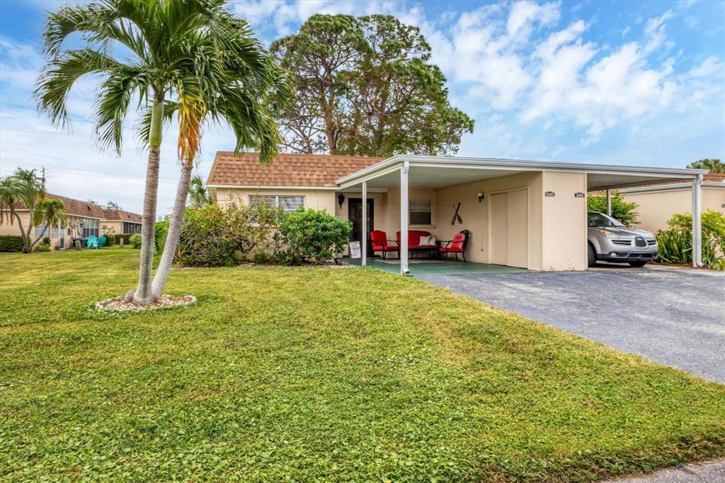 A single-story house with a carport, a palm tree, and a green lawn — 4803 PARK ACRES DRIVE, BRADENTON, FL