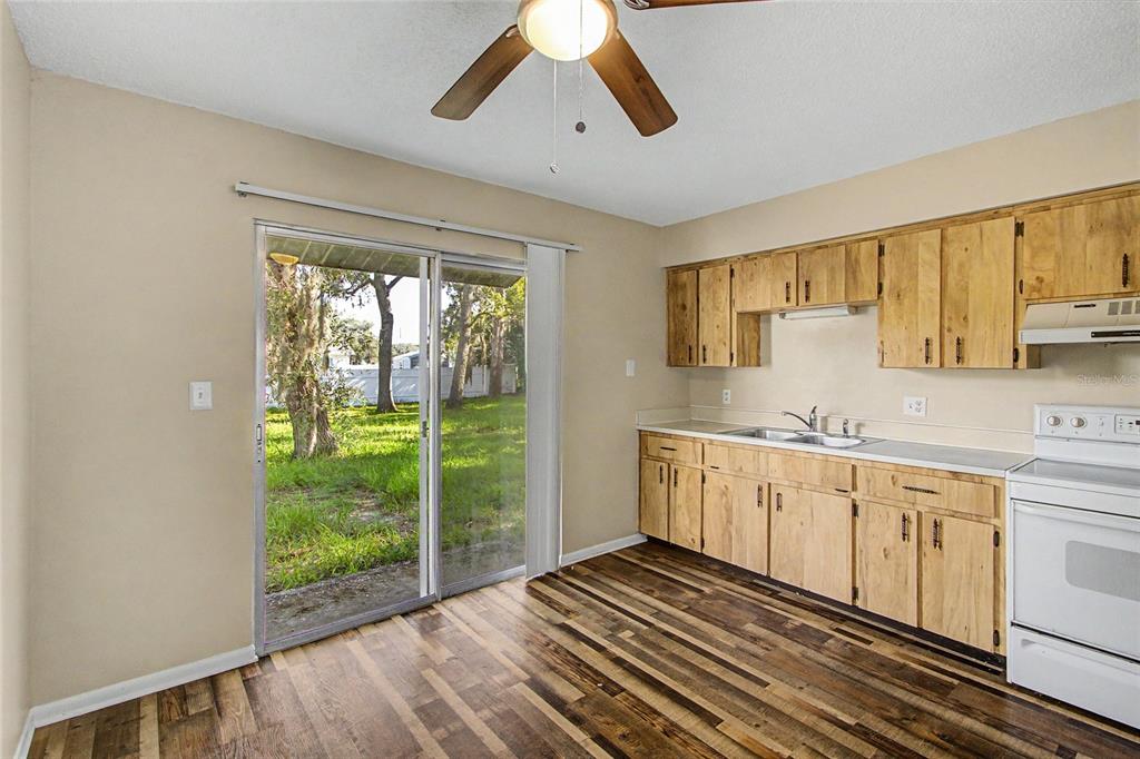 This is a floor plan showing a garage, kitchen, living room, two bedrooms, and bathrooms — 1733 LARKIN ROAD, SPRING HILL, FL