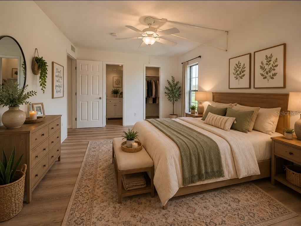 A bedroom features a wooden bed frame, a dresser, a ceiling fan, and neutral decor — 4812 JASPER DRIVE UNIT 101, NEW PORT RICHEY, FL