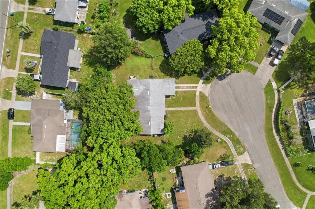 An aerial view of a single-story house with a gray roof, garage, and front walkway — 1220 SIENNA COURT, DELTONA, FL