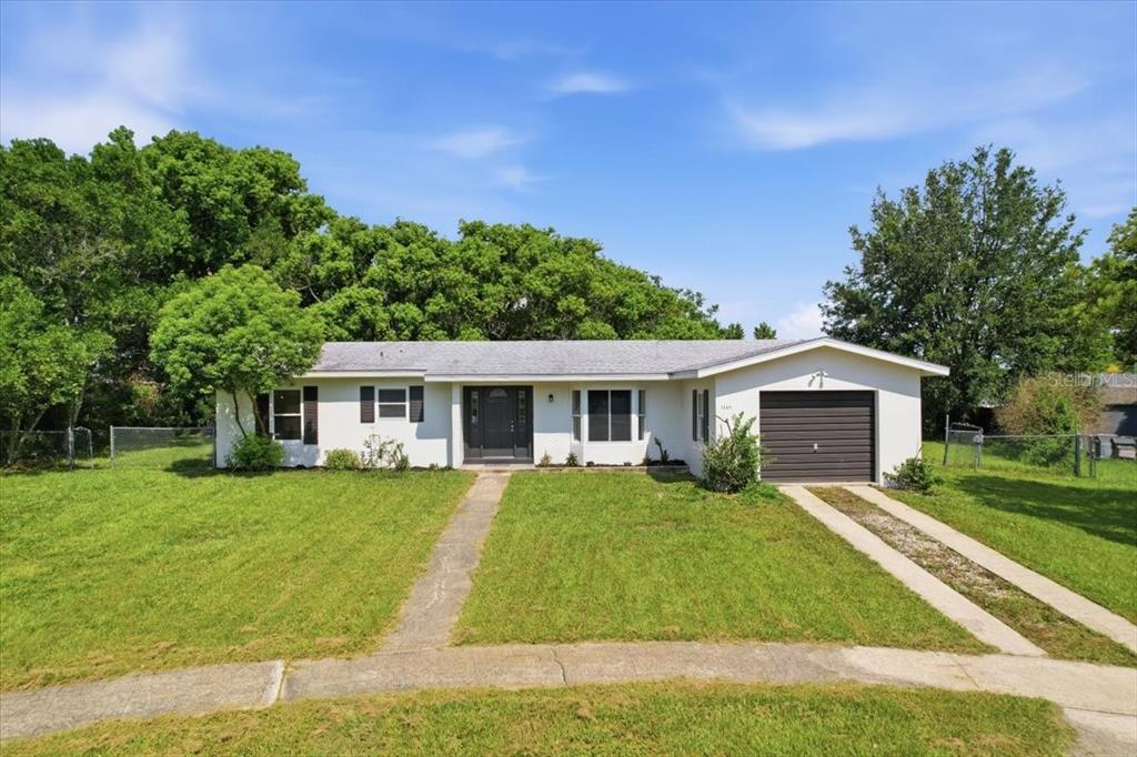 A bright room features light wood flooring, white walls, and a large bay window — 1220 SIENNA COURT, DELTONA, FL