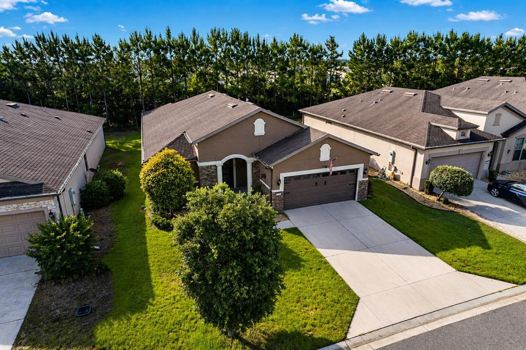 An aerial view shows a brown single-story house with a garage and a grassy lawn — 9221 SW 70TH LOOP, OCALA, FL