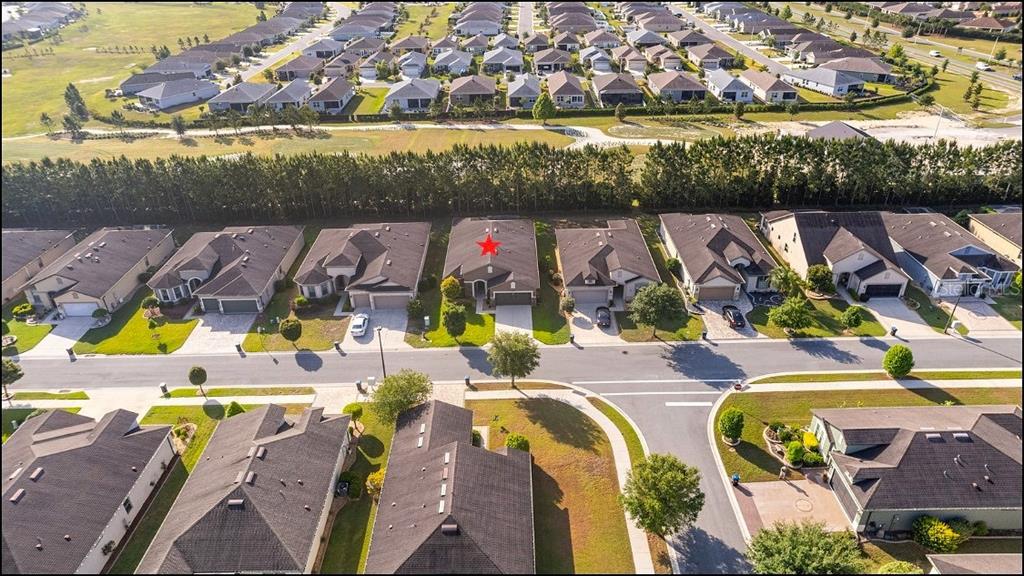An aerial view of a suburban neighborhood featuring single-family homes with dark shingled roofs — 9221 SW 70TH LOOP, OCALA, FL
