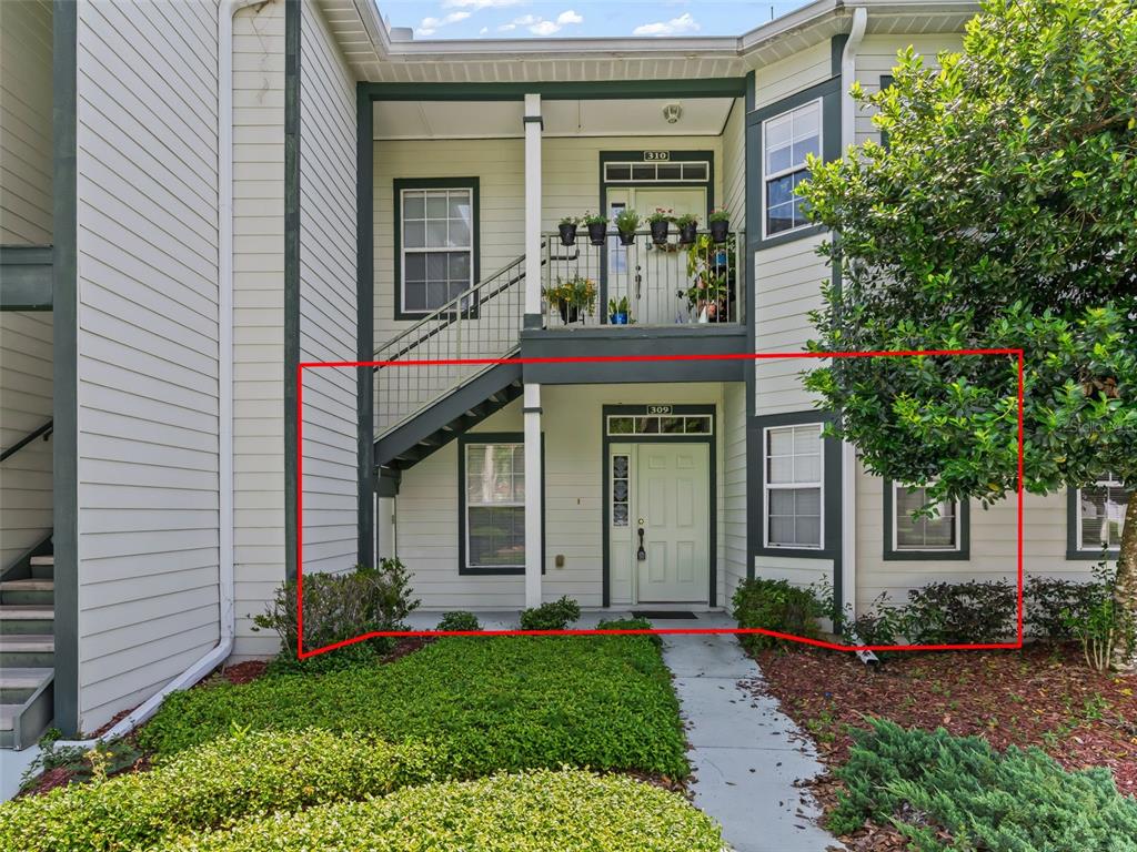 The exterior of a two-story apartment building features a ground-level unit with a front door — 231 NE 28TH AVENUE UNIT 309, OCALA, FL