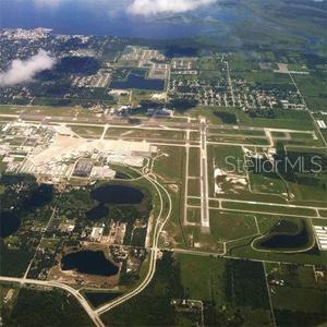 An aerial view of an airport with runways, taxiways, and surrounding residential and natural areas — 4045 HONEY BEE PT ROAD, SANFORD, FL