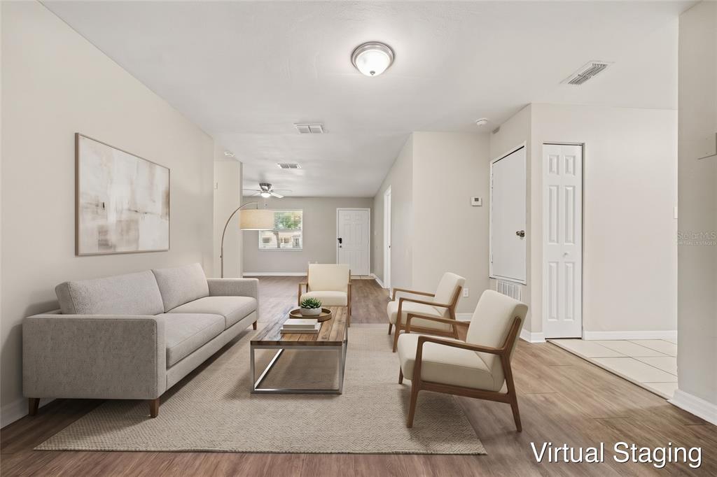 An interior view of a room with light gray walls and wood-look flooring — 1895 S IVEY LANE, ORLANDO, FL