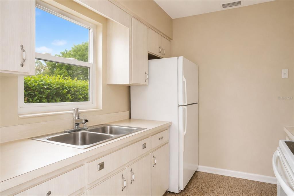 A kitchen features light wood cabinets, a double-basin sink, and a white refrigerator — 6008 BOB HEAD ROAD, PLANT CITY, FL
