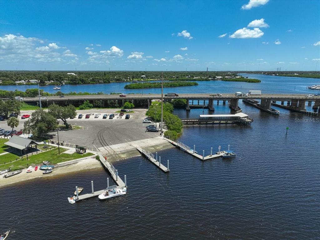 An aerial view shows a boat ramp, parking lot, and a bridge over a waterway — 8814 RIVERLACHEN WAY, RIVERVIEW, FL
