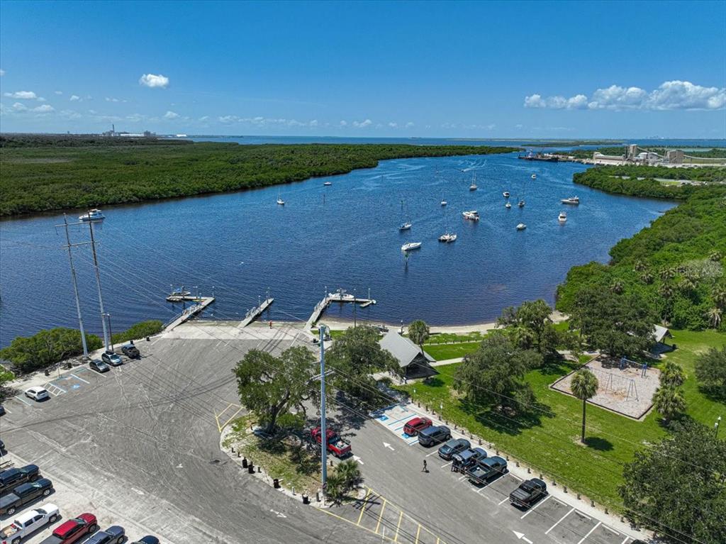 An aerial view shows a boat ramp, parking lot, and park area along a river — 8814 RIVERLACHEN WAY, RIVERVIEW, FL