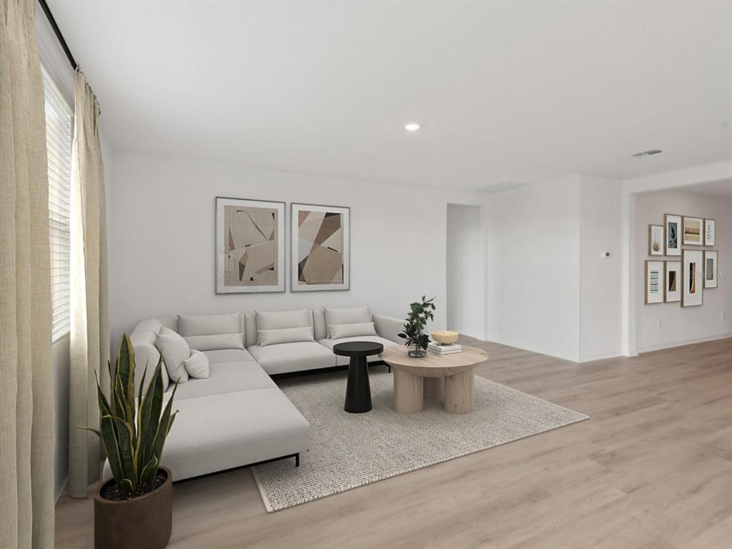 This is a digital rendering of a modern living room featuring a sectional sofa — 1789 FOREST RUN LANE, AUBURNDALE, FL