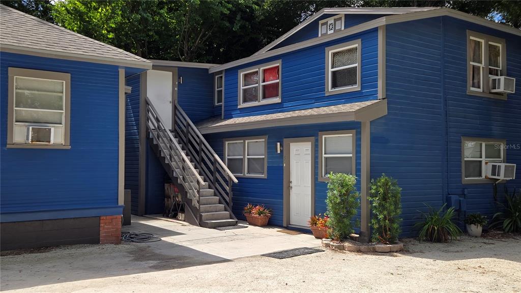 A blue two-story building with an exterior staircase and a gravel driveway — 2306 N MORGAN STREET, TAMPA, FL