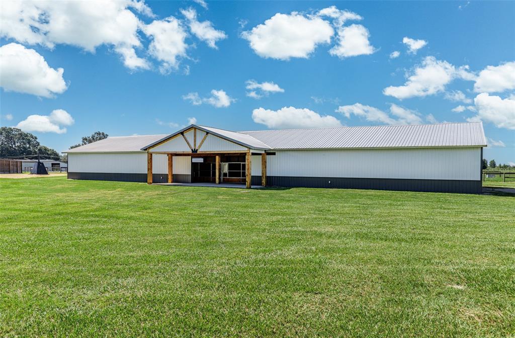A long, single-story metal building with a covered entrance sits on a grassy field — 1285 102ND BLVD A UNIT (Option 1), WILDWOOD, FL