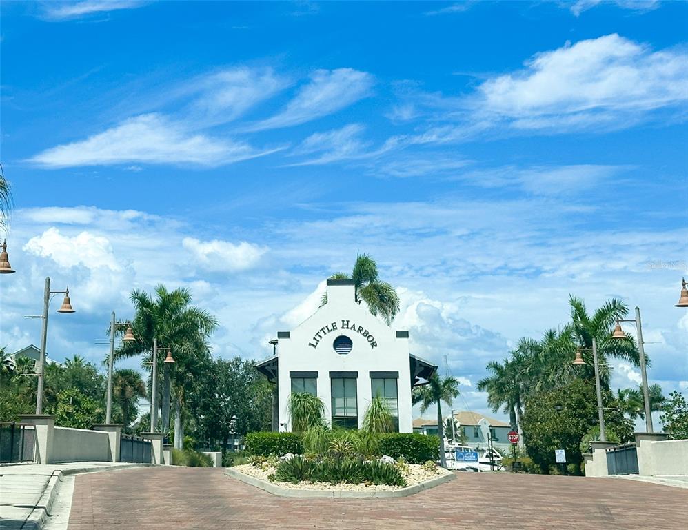 The entrance to the Little Harbor community features a white building with a central sign — 611 DESTINY DRIVE UNIT 501, RUSKIN, FL