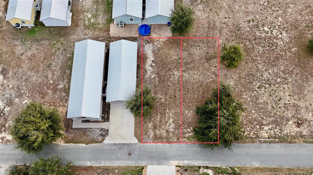 An aerial view shows two adjacent vacant lots outlined in red next to a house — 000 SW 879TH STREET, STEINHATCHEE, FL