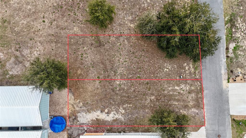 An aerial view shows two adjacent rectangular vacant lots outlined in red next to a road — 000 SW 879TH STREET, STEINHATCHEE, FL