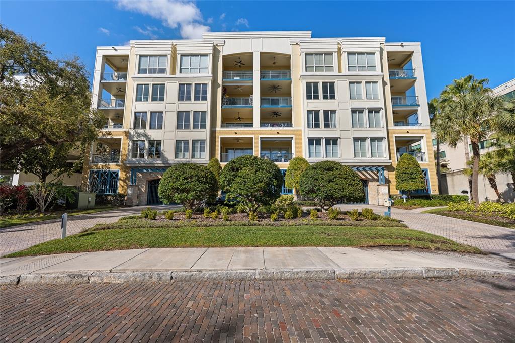 A multi-story apartment building with balconies and a brick driveway in front — 509 W BAY STREET UNIT 305, TAMPA, FL