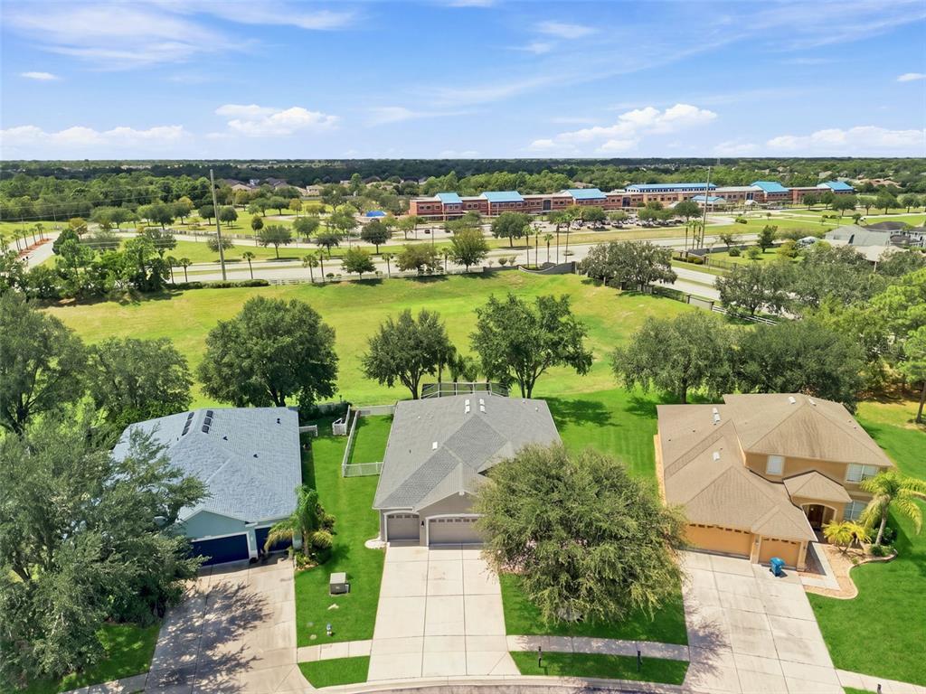 A kitchen with white cabinets, stainless steel appliances, a center island, and dark wood flooring — 4327 CANONGATE COURT, SPRING HILL, FL