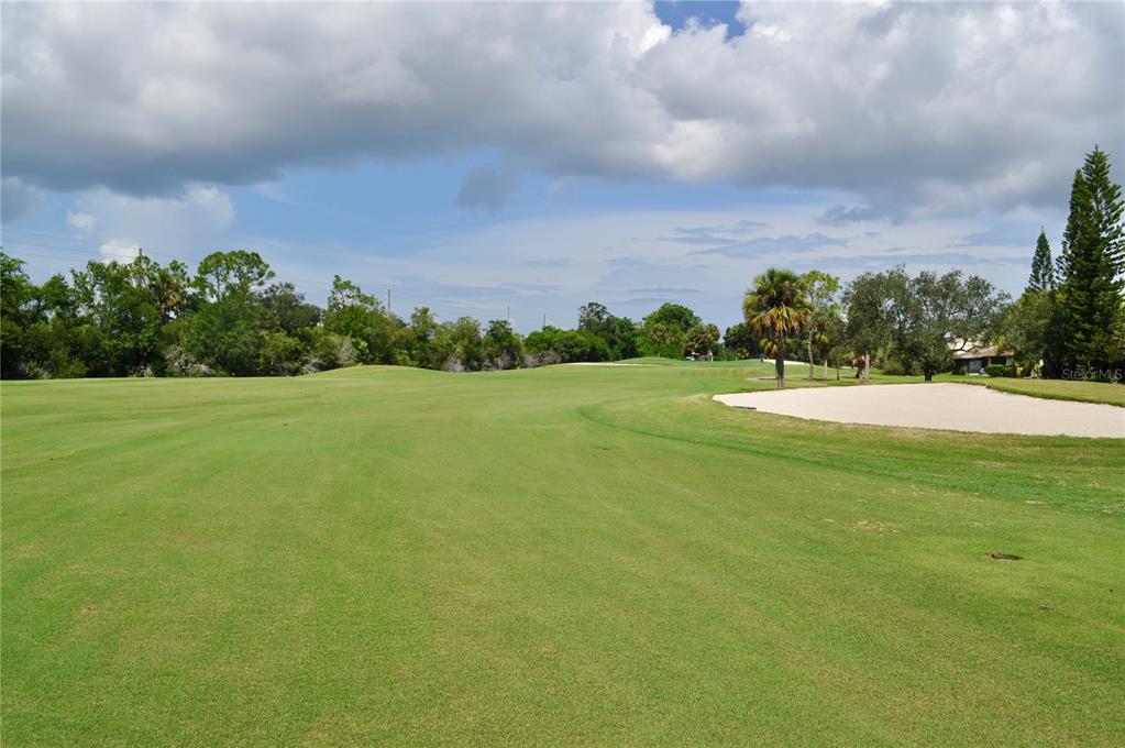 A view of a golf course fairway with a sand bunker and surrounding trees — 150 POOLE PLACE, OLDSMAR, FL