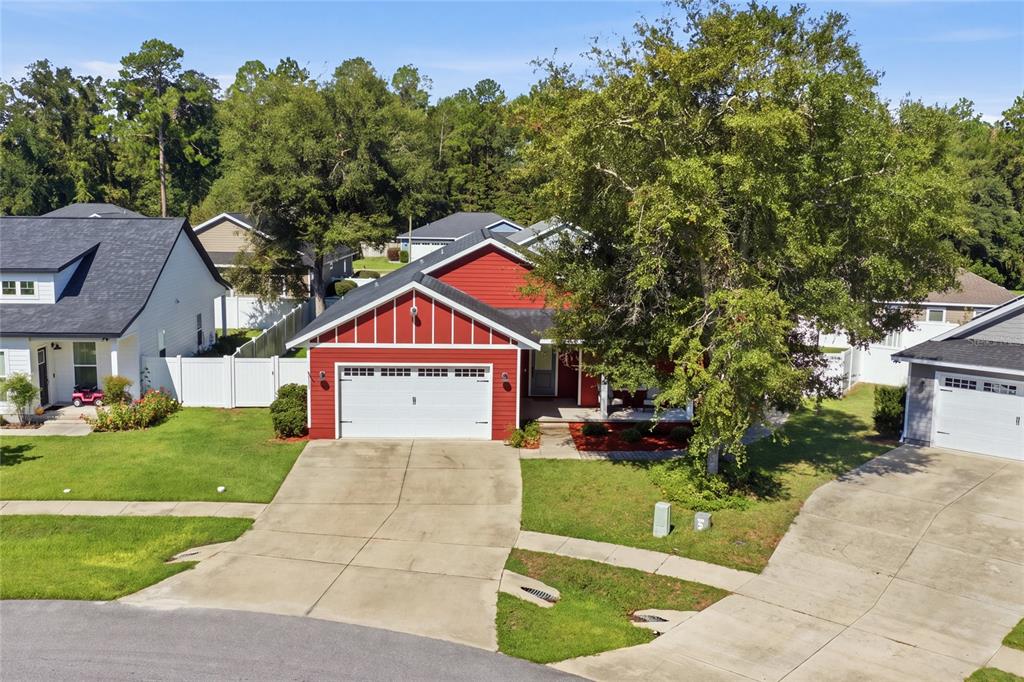 An aerial view of a red house with a white garage and a large tree — 20104 NW 248TH STREET, HIGH SPRINGS, FL
