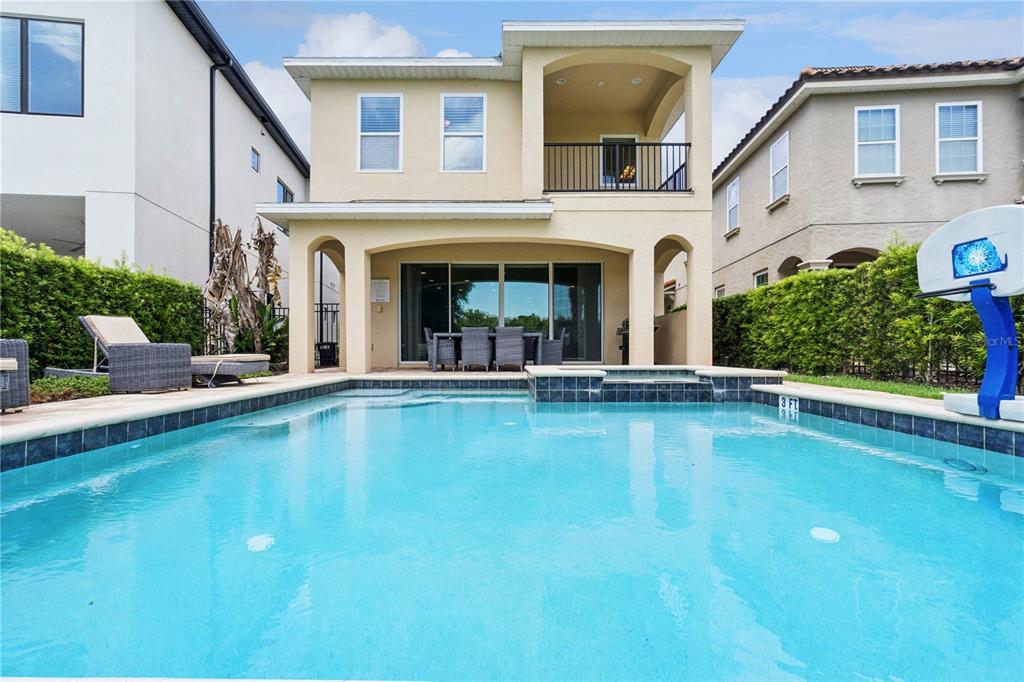 A two-story house with a backyard swimming pool and a covered patio area — 785 DESERT MOUNTAIN COURT, KISSIMMEE, FL