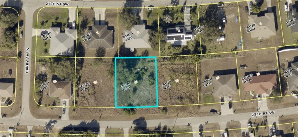 This is an aerial map showing a vacant, rectangular residential lot highlighted in blue — 4452 28TH STREET SW, LEHIGH ACRES, FL