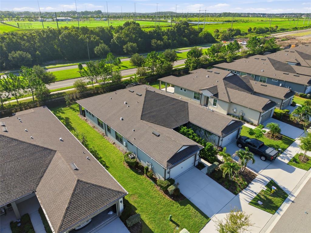 An aerial view shows several suburban houses with dark shingled roofs and concrete driveways — 6352 MOORING LINE CIRCLE, APOLLO BEACH, FL
